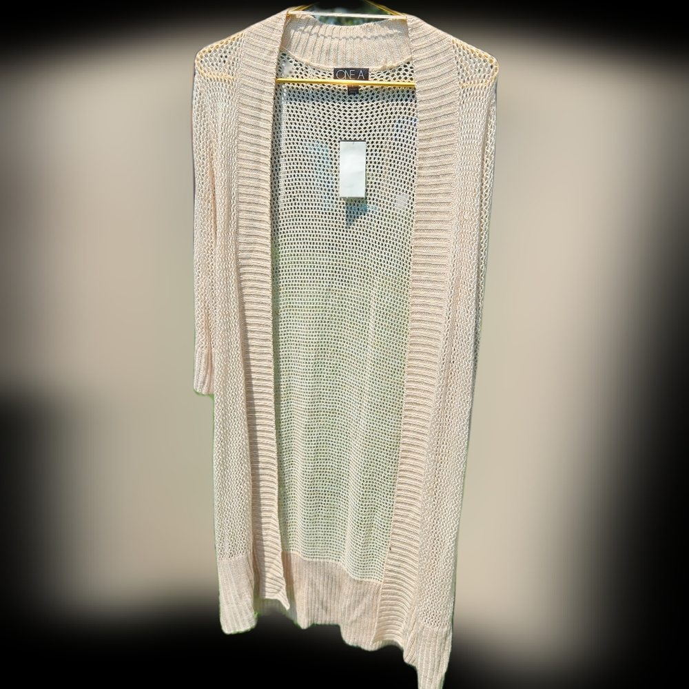 NEW w tags. Long light sweater in warm cream. Loose knit, knee length
